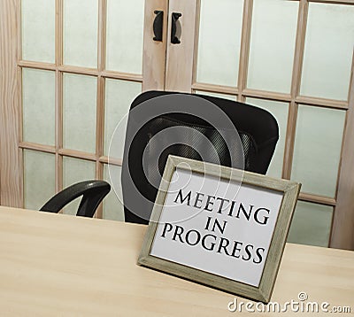Meeting in progress sign