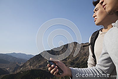 Men hiking and using GPS