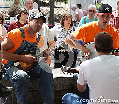 Men playing stringed instruments at festival