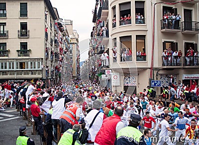 Men run from bulls in street Estafeta