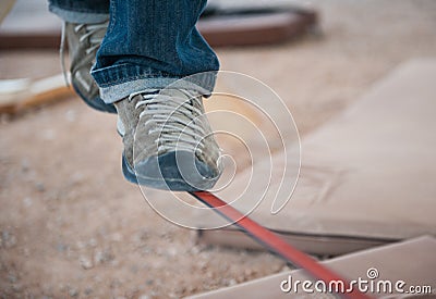 Men s feet in shoes on slackline