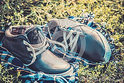 Men s shoes on the grass wrapped in a scarf