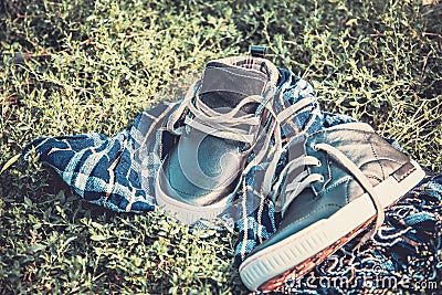 Men s shoes on the grass wrapped in a scarf