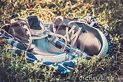 Men s shoes on the grass wrapped in a scarf