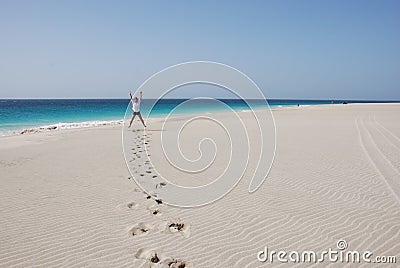 Men on sandy beach - blue ocean and sky