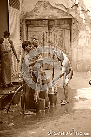 Men washing clothes Sepia. Old Delhi, India.