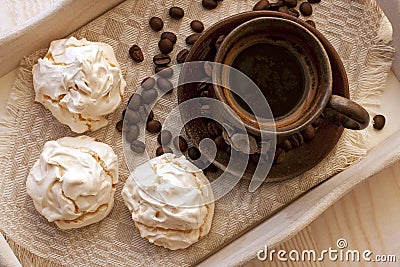 Meringue cookies and cup of aromatic coffee