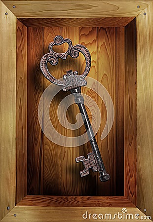 Metal key in wooden box