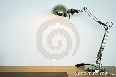 Metal lamp on the wooden desk