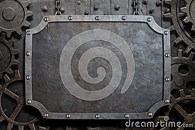 Metal plate hanging on chains over medieval gears