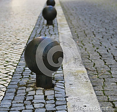 Metal round barrier in stone street
