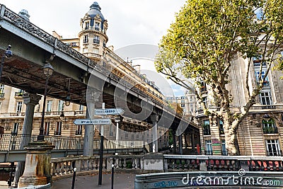 Metro runs high between buildings in Paris