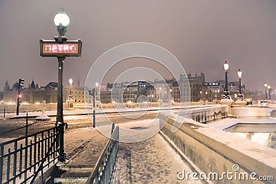 Metro sign under snow in Paris