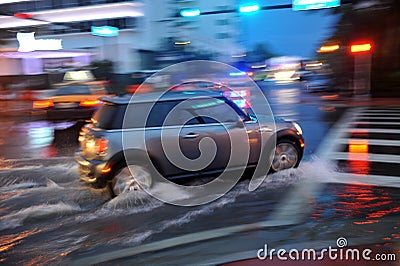 MIAMI BEACH, FL - JULY 18: Cars moving on flooded streets and roads of Miami South Beach after heavy rains