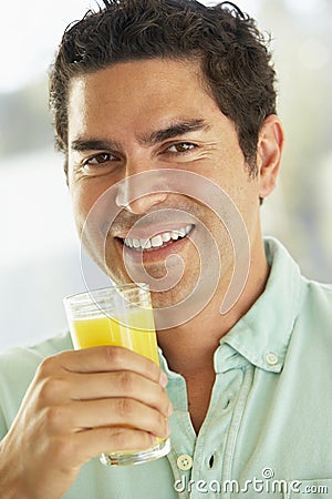 Mid Adult Man Holding A Glass Of Orange Juice
