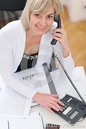 Middle age business woman making phone call