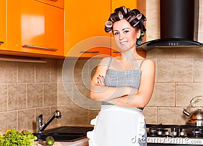 Middle-age woman with apron in the kitchen