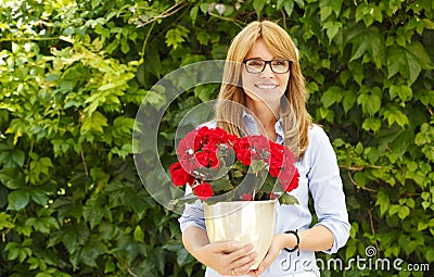 Middle age woman with flower pot