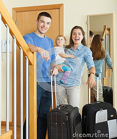 Middle-aged couple with baby with luggage