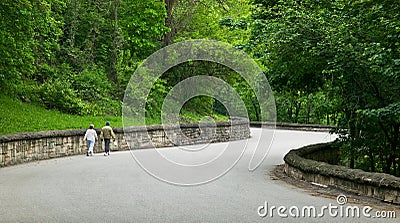 Middle Aged Couple Walking Down Rural Road