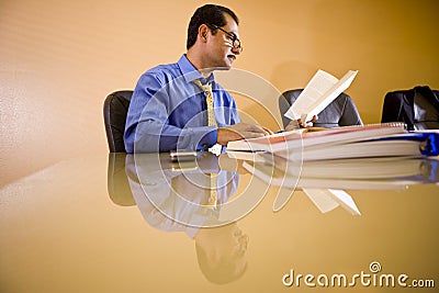 Middle-aged Hispanic businessman working in office
