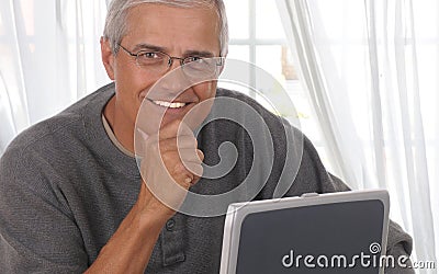 Middle Aged Man in Living room with computer