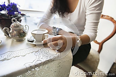 Beautiful calm young woman having morning coffee