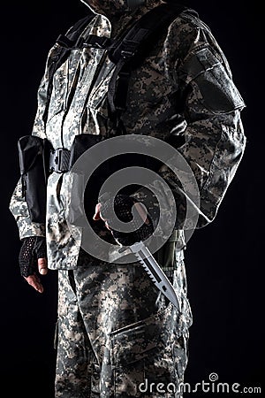 Military man with a knife in a hand close up