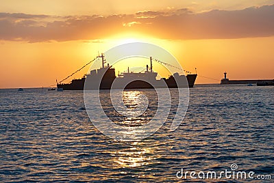 Military ship against sunset