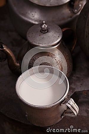 Milk mug and old teapot and kettle in a kyrgyz yurt kitchen