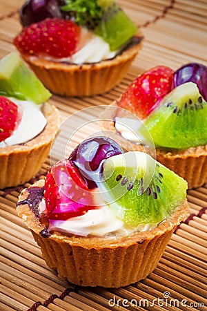 Mini fruit tart and wooden background