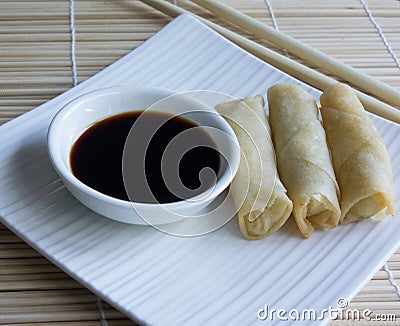 Mini Spring Rolls, Chopsticks, Soy Sauce On Bamboo Mat.