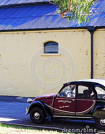 Mini vintage promotional car outside side buildings at entrance of Seppeltsfield estate