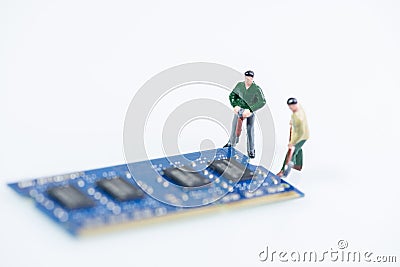 Miniature technician working on the computer RAM close up over white background