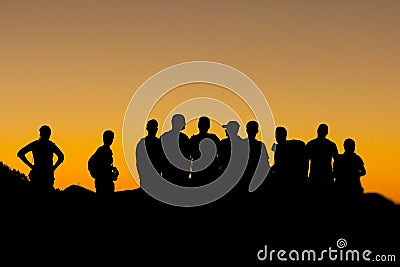 Misaligned group of people silhouettes at sunset