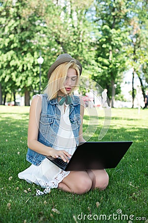 Mixed race college student sitting on the grass working