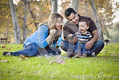 Mixed Race Ethnic Family Playing with Bubbles