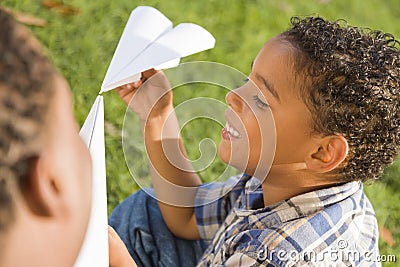 Mixed Race Father and Son Playing Paper Airplanes