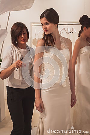 Model wearing wedding dress at Si Sposaitalia in Milan, Italy