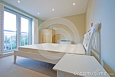 Modern bedroom in white with simple furniture