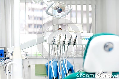 Modern dental tools, patient chair and special light stand