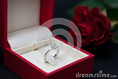Modern diamond engagement ring in red box