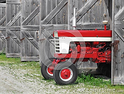 Modern farm tractor in an old shed