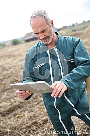 Modern farmer using tablet in fields