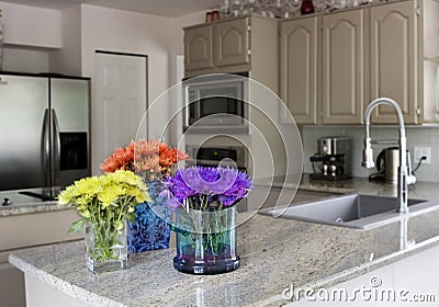 Modern kitchen with flowers on counter