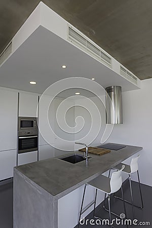 Modern kitchen with gray floor and white wall