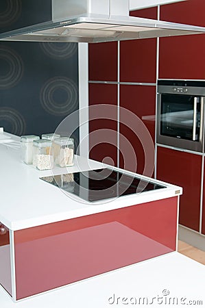 Modern kitchen with oven in red tones
