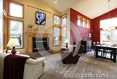 Modern large open living room with red wall.