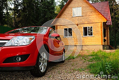 Modern wooden house and the red car