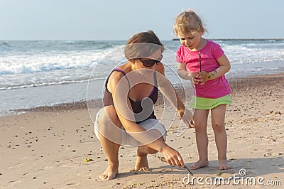 Mom And Daughter Plays On The Beach Stock Photo - Image: 47550916